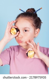 The Girl Holding Rolls Have A Face Like Binoculars. Japanese Cuisine Home Delivery. On A White Background In An Orange Dress. Long Curly Hair. It Is Ridiculous And Stupid.