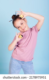 The Girl Holding Rolls Have A Face Like Binoculars. Japanese Cuisine Home Delivery. On A White Background In An Orange Dress. Long Curly Hair. It Is Ridiculous And Stupid.