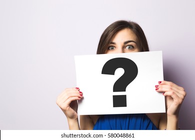 Girl holding a signboard with a question mark