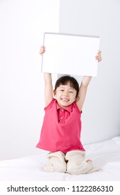 Girl Holding A Sketchbook