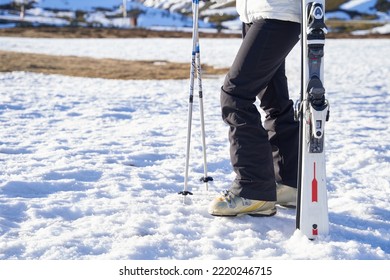 Girl Holding Skis Not Person. Only Legs