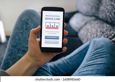 Girl holding smart phone with dental care concept on screen