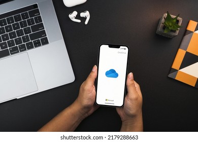 Girl Holding A Smartphone With Microsoft Onedrive Cloud Storage App On The Screen On Black Background Table. Office Environment. Rio De Janeiro, RJ, Brazil. July 2022.