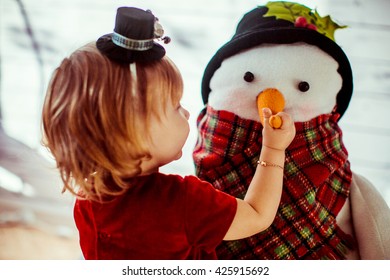 Girl Holding A Snowman On The Nose