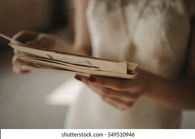 A Girl Holding A Stack Of Old Letters.