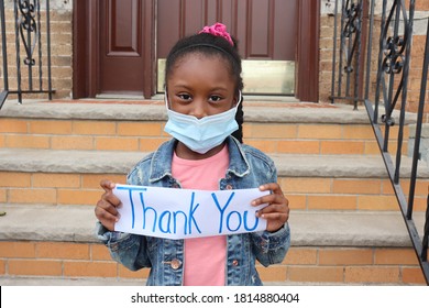 Girl Holding Thank You Sign Outside House Front Steps And Door Background