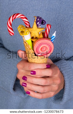 girl holding a waffle cup with sweets