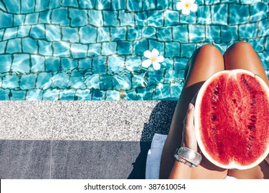 Girl Holding Watermelon In The Blue Pool, Slim Legs, Instagram Style. Tropical Fruit Diet. Summer Holiday Idyllic.