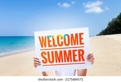 Girl Holding Welcome Summer Sign Over Beach Background, Summer Holiday Season, Outdoor Day Light