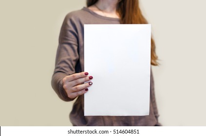 Girl Holding White A4 Blank Paper Vertically. Leaflet Presentation. Pamphlet Hold Hands. Woman Show Clear Offset Paper. Sheet Template. Booklet Design Sheet Display Read First Person.