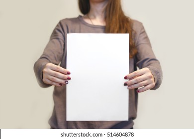 Girl Holding White A4 Blank Paper Vertically. Leaflet Presentation. Pamphlet Hold Hands. Woman Show Clear Offset Paper. Sheet Template. Booklet Design Sheet Display Read First Person.