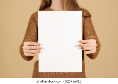 Girl Holding White A4 Blank Paper Vertically. Leaflet Presentation. Pamphlet Hold Hands. Woman Show Clear Offset Paper. Sheet Template. Booklet Design Sheet Display Read First Person