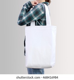 Girl Is Holding White Blank Cotton Tote Bag, Design Mockup.