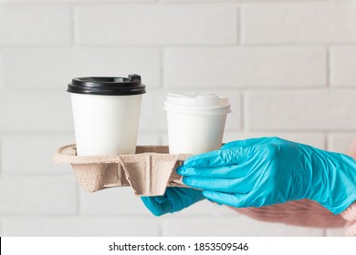 Girl Holding White Paper Cup Of Takeaway Coffee In The Medical Gloves. Place For Your Text Or Log. Coffee To Go In Holder.