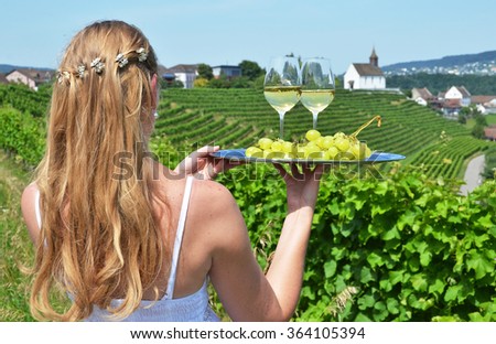 Girl holding wine and grapes. Vineyards of Rheinau, Switzerland