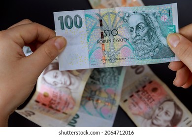 A girl holds a crown in her hands on a background of crowns. Czech money. European currency. - Shutterstock ID 2064712016