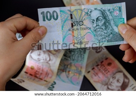A girl holds a crown in her hands on a background of crowns. Czech money. European currency. Foto stock © 