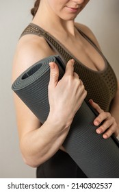 Girl Holds Her Grey Yoga Mat Close Up Photo No Face