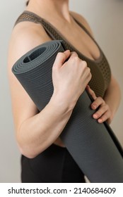 Girl Holds Her Grey Yoga Mat Close Up Photo No Face