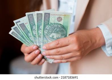 the girl holds in her hands banknotes money polish zlotys and pennies coins salary for payment - Shutterstock ID 2187183691