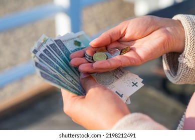 the girl holds in her hands banknotes money polish zlotys and pennies coins salary for payment - Shutterstock ID 2198212491