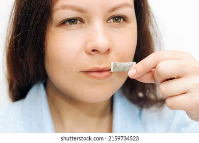 The Girl Holds In Her Hands A Pillow Snbcha Nicotine Pouch.