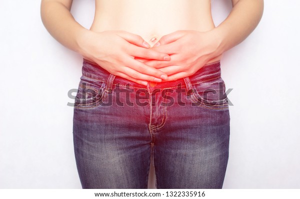 The girl holds her stomach\
for an umbilical hernia of the abdomen, pain, omphalocele,\
discomfort
