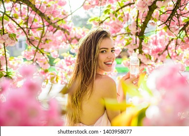 Girl holds micellar water bottle. Face care products. Female cosmetics. Tonic, lotion, micellar water. Beauty treatment. Cleansing water. Cosmetology. Skincare. Makeup remover. Nature herbal cosmetic. - Powered by Shutterstock