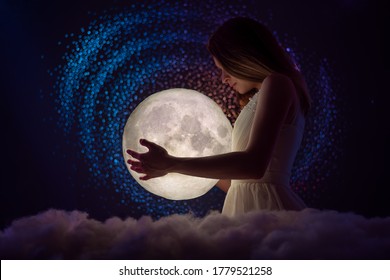 The girl holds the moon in her hands, tender photography, female magic. Against the background of stars - Shutterstock ID 1779521258