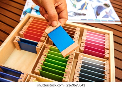 Girl Holds A Tablet From A Montessori Color Box, Gradient Colors To Match The Visual Sense.