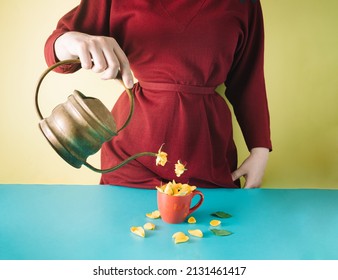 The girl holds a vintage teapot and pours yellow roses into a cup. Minimal layout spring composition. - Shutterstock ID 2131461417