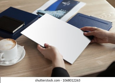 The Girl Holds The White Magazine In Hand