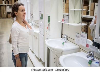 Girl In Home Improvement Store Chooses Bathroom Furniture