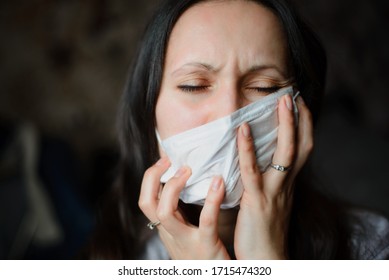 Girl At Home In A Protective Mask Tries To Rip Her Off