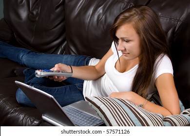 Girl at Home watching tv with a remote control