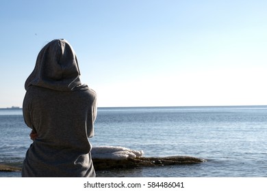 girl in a hood near the sea, beautiful nature, beach and sea