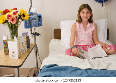 Girl In Hospital Bed Reading Magazine At Camera With Get Well Soon Cards