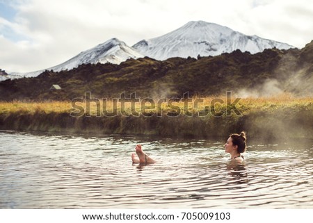 Girl in a hot spring in Iceland Landmannalaugar. Relaxing in a natural hot bath.