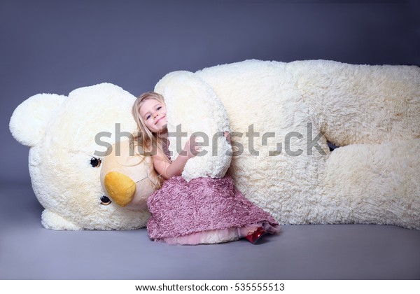 hugging big teddy bear