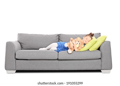 Girl Hugging A Teddy Bear And Sleeping On Couch Isolated On White Background