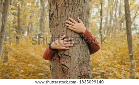 Similar – hands of woman hugging a tree