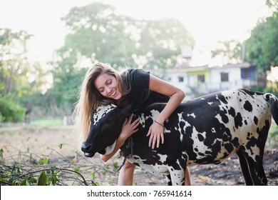 The Girl Hugs The Cow