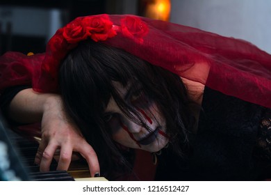girl in the image of the "dead bride" lay down on the piano keys. Concept - mysticism, occultism, magic