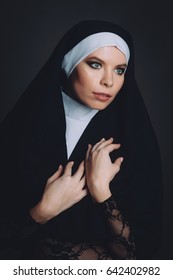Girl in the image of a nun on a black background