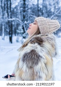 The Girl Inhales The Frosty Air In The Park. The Concept Of A Winter Walk In The Park.