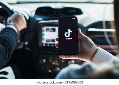 Girl Inside Car Holding Smartphone With Tik Tok App On Screen. Rio De Janeiro, RJ, Brazil. August 2022.