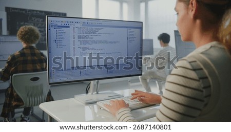 Girl at Institute Doing Practical Coding Project. In Game Dev Workshop, Young Woman Typing Program Code on Monitor. Concept Modern Education, Studying Computer Science, Future Technology Skills.