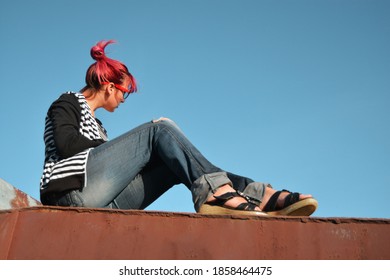 Girl In Jeans Against The Sky