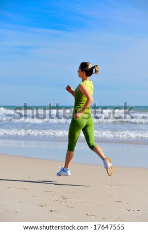 girl jogging on the beach at sunrise