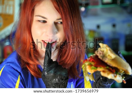 Girl with a juicy burger. Beautiful happy young woman with tasty burger on light background